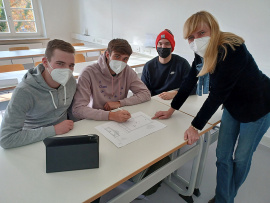 Studiengangleiterin Prof. Dr. Jana Bochert bespricht mit (von links) Patrick Seel, Maximilian Gottschall und Shayan Thiele das Projekt. 