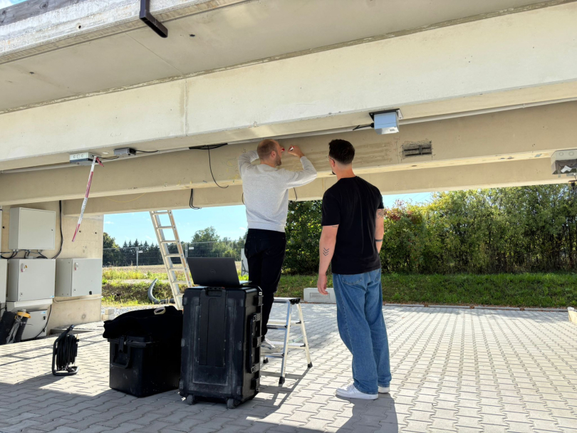 Die Forschenden testeten ihre Methoden auch an echten Brücken. Hier werden Glasfaserkabel auf eine Brückenunterseite geklebt. Foto: Mark Alexander Ahrens 